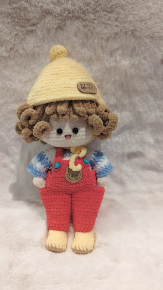 Handmade crochet doll in red overalls