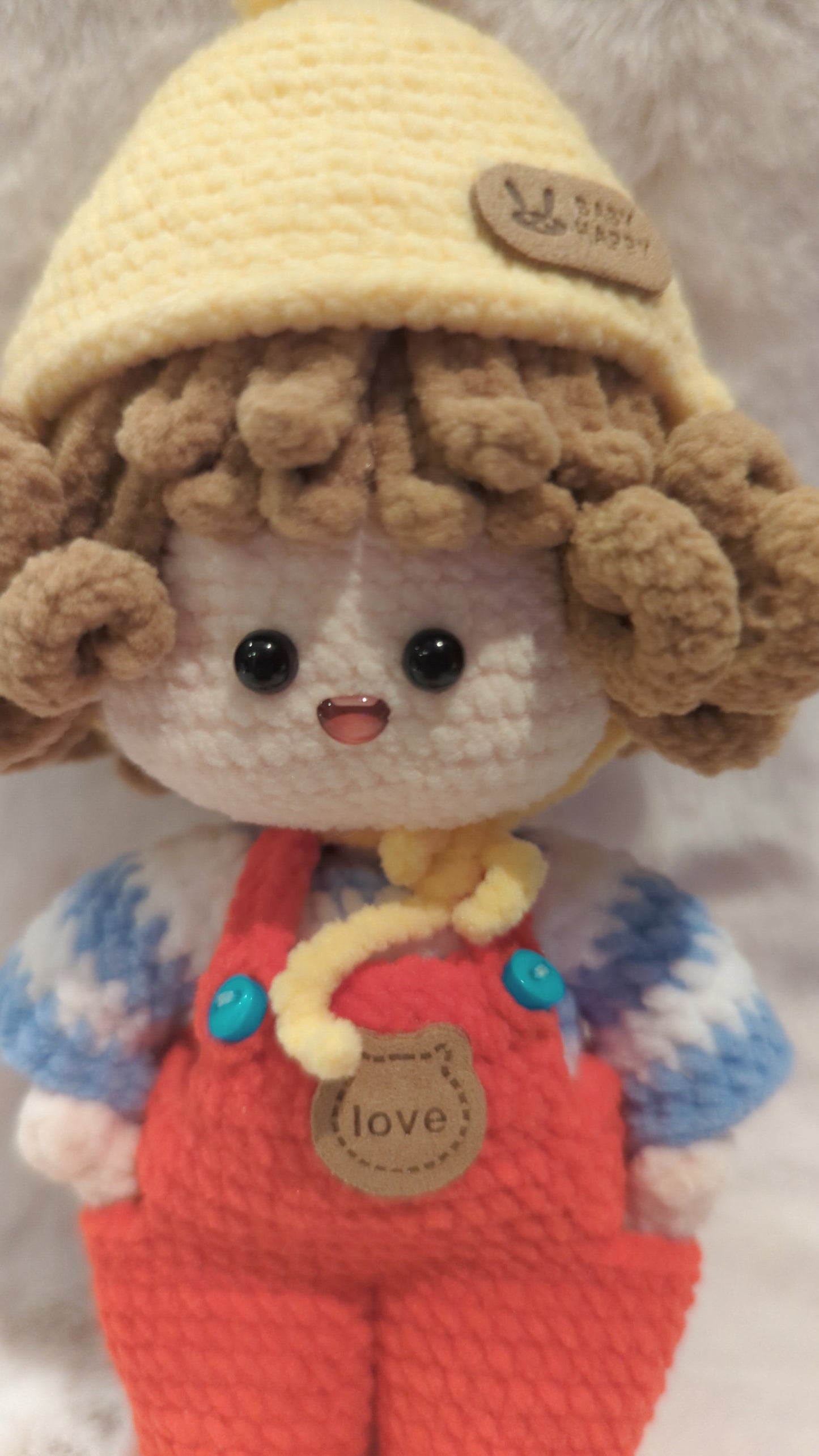 Handmade crochet doll in red overalls